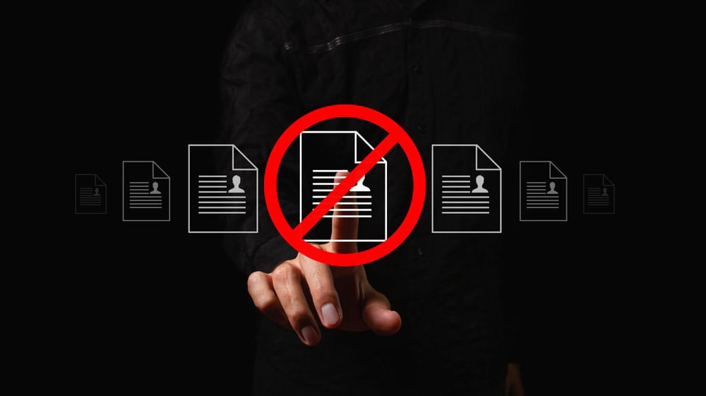 Blocked document icon represents Link Socially’s regulated SEO controls—reducing compliance risk while enabling scalable visibility growth.